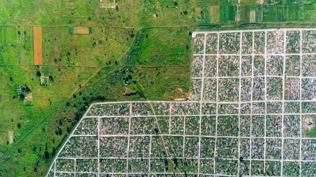 An aerial view of a modern industrial park, showcasing various business operations. Solar panels are visible on some rooftops, representing sustainable and tax-efficient investment choices.