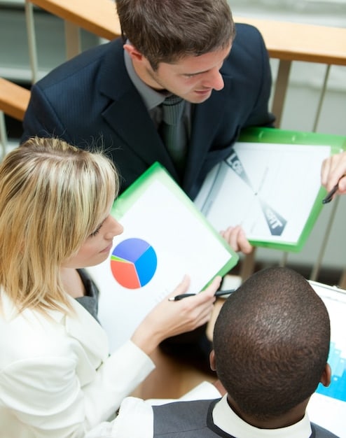 A close-up shot of a business owner reviewing financial documents with a focused expression, highlighting the importance of careful planning.