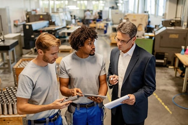 A group of engineers and technicians working on the design and development of new manufacturing technologies. The image should highlight innovation, collaboration, and the use of advanced tools and software.