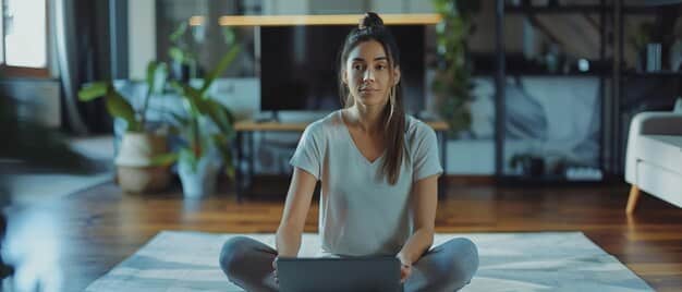 A remote worker practicing yoga in their home office with natural light streaming in, emphasizing the importance of physical and mental well-being.