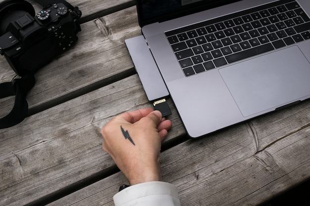 A close-up shot of a hardware wallet device connected to a laptop via USB. The screen of the hardware wallet should show a transaction confirmation request, highlighting the security features.