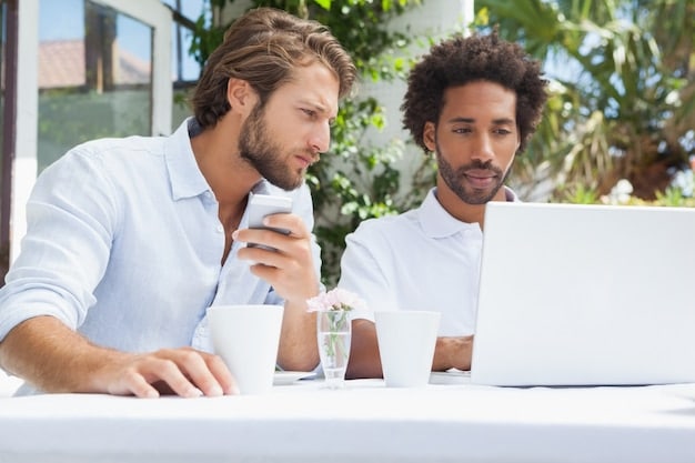 A mentor advising a young entrepreneur in a coffee shop, both looking at a laptop screen. The setting is casual and collaborative, emphasizing the supportive relationship.