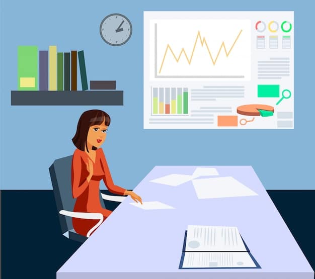 A person sitting at a desk, analyzing charts and graphs on a computer screen. The person is wearing glasses and appears focused, with post-it notes and reports scattered around the desk.