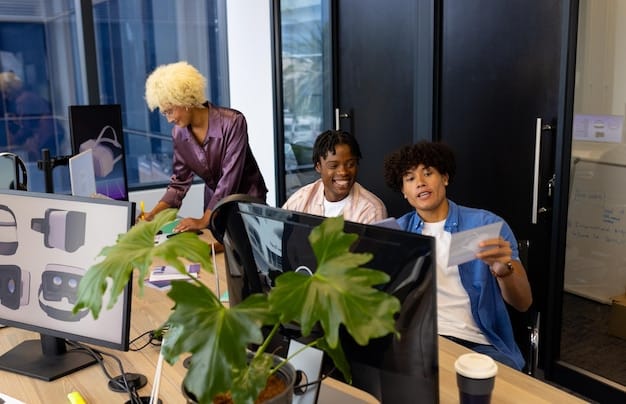 A diverse team of developers working collaboratively on computers in a modern office setting, representing the agile development process and the importance of teamwork in building a successful MVP.