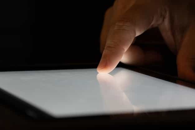 A close-up of a hand signing a patent application on a digital tablet, with holographic images of inventions floating above, symbolizing the process of securing intellectual property rights.