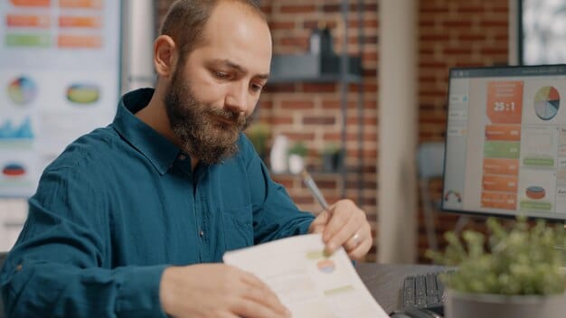 A close-up shot of a mentor reviewing a business plan with a startup founder in a bright, contemporary office setting. The mentor is pointing to a specific section with a pen, indicating a point of discussion.