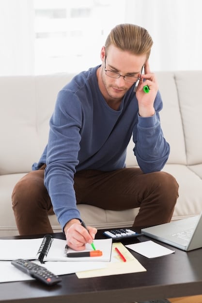 A person using a calculator and reviewing financial documents, emphasizing the importance of budgeting and financial assessment when planning for homeownership. The scene should suggest careful thought and organized financial management.