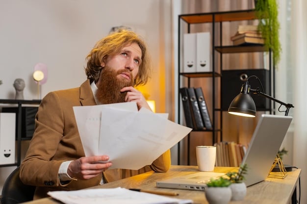 A person sitting at a desk, reviewing financial documents with a focused and determined expression.