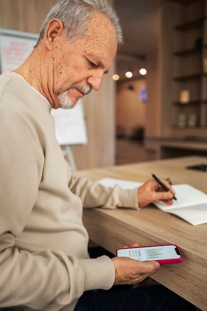 A close-up shot of a person using a retirement planning app on a smartphone. The app displays colorful charts showing projected retirement income, expenses, and investment growth. The background is intentionally blurred to keep the focus on the phone screen and the user's engagement.