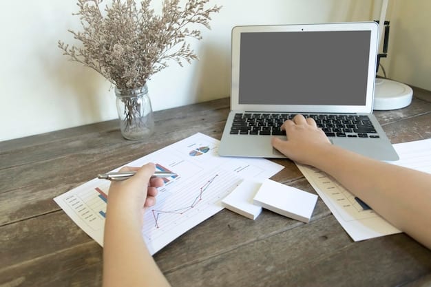 A close-up of a financial advisor's hands pointing at a detailed family budget spreadsheet on a laptop, highlighting income, expenses, and savings goals.